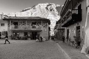 House with balcony in shadow of mountain